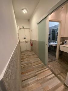 a hallway leading to a room with a bathroom at My Friends in Florence
