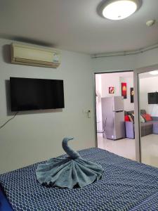 a room with a bed with a towel on it at Grand Beach 2, apartment by Wheelie75 in Ban Tha Fat +10 photos