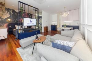 a living room with two couches and a tv at Eagle's Nest Ljubljana in Ljubljana