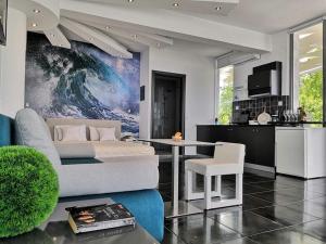 a living room with a couch and a table and a kitchen at Hotel George suite 1 in Limenas