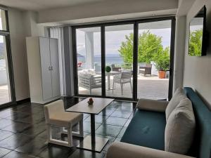 a living room with a couch and a table at Hotel George suite 1 in Limenas