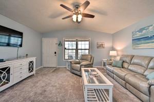 a living room with a couch and a ceiling fan at PCB Resort Condo with Private Balcony and 3 Pools! in Panama City Beach