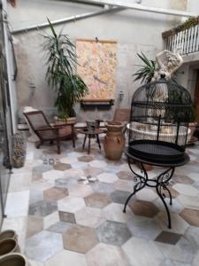 a room with a bird cage on a tiled floor at LA KAIGA in Saint-Rambert-en-Bugey