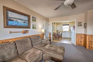 a living room with a couch and a kitchen at Rockaway Beach Escape with View Steps to Sand! in Rockaway Beach