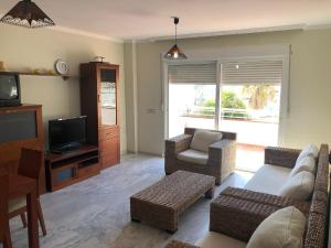 a living room with a couch and a tv at Tortugas 16 in Carboneras