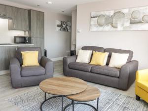 a living room with two couches and a table at Seascape in Burntisland