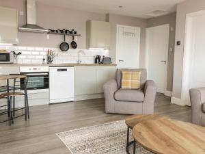 a kitchen and living room with a table and chairs at Shore View in Burntisland
