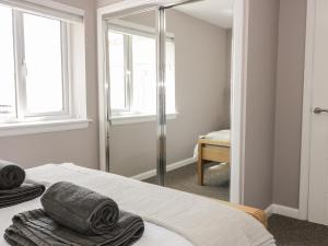 a bedroom with a bed and a mirror at Shore View in Burntisland