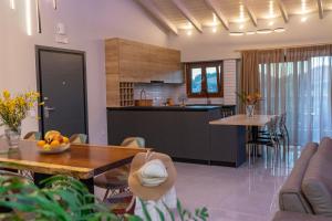 a kitchen and living room with a table and chairs at Emily Apartments in Nydri