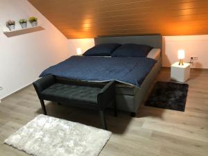 una camera con un letto e una panca di Baumberger Ferienhaus mit Garten & Wintergarten mit 3 Schlafzimmern & 2 Bädern a Nottuln