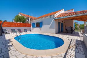a swimming pool in the backyard of a house at Villa Nika in Jasenice