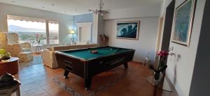 a living room with a pool table in it at Villa Santa Mavra in Glinado Naxos