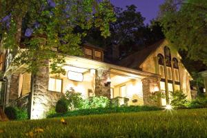 a house lit up at night with a lawn in front at Stonehurst Place Bed & Breakfast in Atlanta