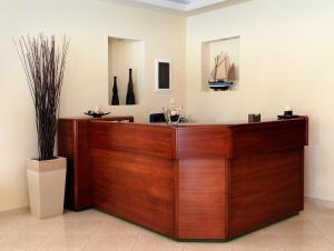 a wooden reception desk in a room with vases at Nepheli Apartments and Studios in Paralia Katerinis