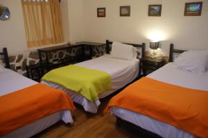 Postel nebo postele na pokoji v ubytování Hotel Samanapaq
