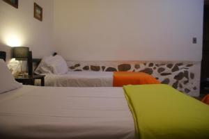 Postel nebo postele na pokoji v ubytování Hotel Samanapaq