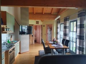 a kitchen and dining room with a table and chairs at Ferienhaus Tonihof in Langdorf im Landkreis Regen