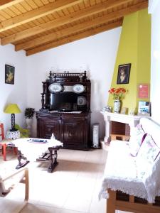 a living room with a couch and a table at Casa Nova da Barreira in Cavaleiro