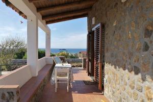 a patio of a house with a table and chairs at Open Space a due passi dal mare in Ustica