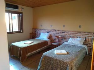 Un pat sau paturi într-o cameră la Pousada do Pampa