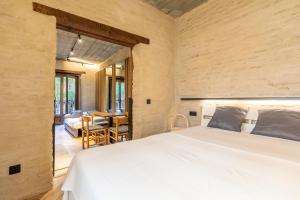 a bedroom with a bed and a living room at Santa Clara Suites Sevilla in Seville