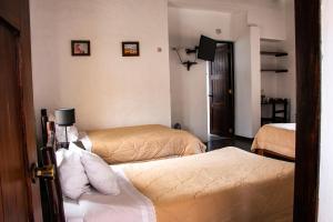 Postel nebo postele na pokoji v ubytování Hotel Samanapaq