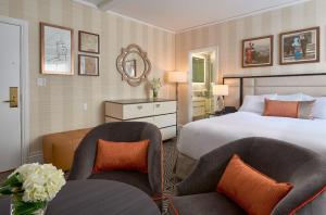 a hotel room with a bed and two chairs at Inn at Union Square in San Francisco