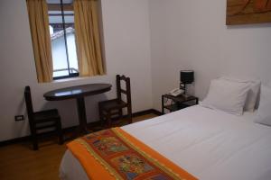Postel nebo postele na pokoji v ubytování Hotel Samanapaq