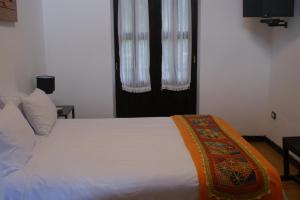 Postel nebo postele na pokoji v ubytování Hotel Samanapaq