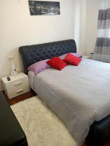 a bedroom with a bed with red pillows on it at Luna in Cavalcaselle