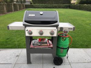 a gas grill with a green thermos at Villa KARIN in Oostduinkerke