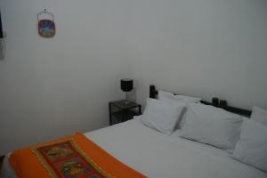 Postel nebo postele na pokoji v ubytování Hotel Samanapaq