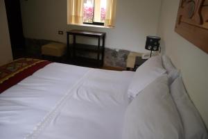 Postel nebo postele na pokoji v ubytování Hotel Samanapaq