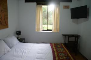 Postel nebo postele na pokoji v ubytování Hotel Samanapaq