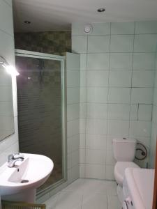 a bathroom with a shower and a toilet and a sink at Kawalerka u Mirka in Świnoujście