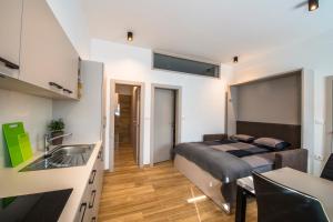 a bedroom with a bed and a sink in a room at Apartmaji Prton Bovec in Bovec