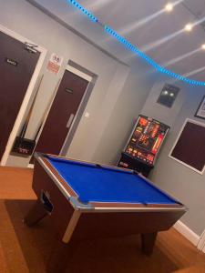 a pool table in a room with a video game at The Boyce Hotel in Blackpool