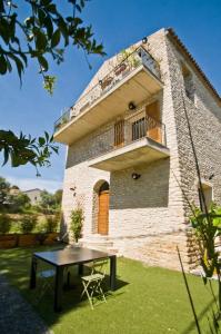 a house with a table in front of it at Casa di Neshama Gabriella in Saint-Florent
