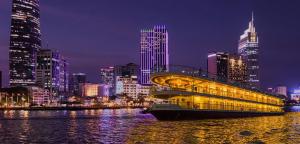 a large building on the water in a city at night at J&K Hotel in Ho Chi Minh City