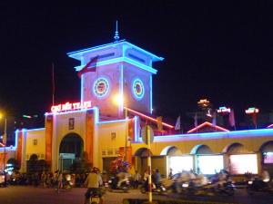 a building with a clock tower at night at J&K Hotel in Ho Chi Minh City