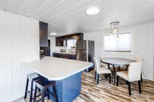 a kitchen and dining room with a table and chairs at Sitting on the Dock of the Bay in Athol