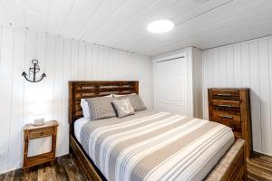 a bedroom with a bed and a dresser in it at Sitting on the Dock of the Bay in Athol