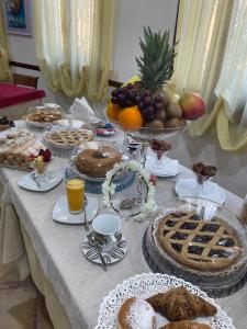 a table full of food and fruit on a table at Il Giglio Affittacamere in Tortolì