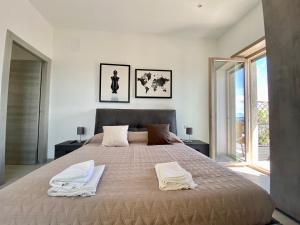 a bedroom with a large bed with two towels on it at PORTO Luxury House Casa Panoramica in Naples