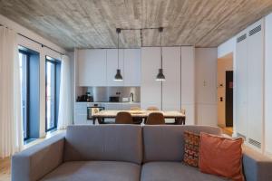 a living room with a couch and a table at FLH Intendente Cozy Industrial Flat in Lisbon