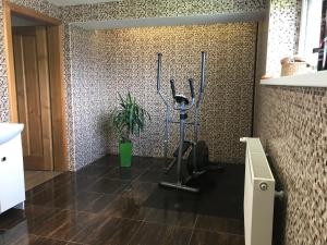 a gym with a treadmill in a room at Apartman Emka 2 in Liptovský Mikuláš