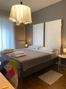 1 dormitorio con 2 camas y lámpara de araña en Le Camere di Garibaldi en Borgomanero