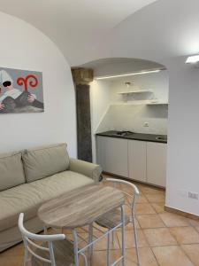 a living room with a couch and a table at CasaTua in Amalfi