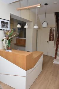 a lobby with a counter with a vase of flowers at Alojamento Local Manuel da Parreira in Figueira da Foz