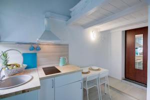 a kitchen with a sink and a counter top at Двухуровневые апартаменты DOMIGO in Voronezh